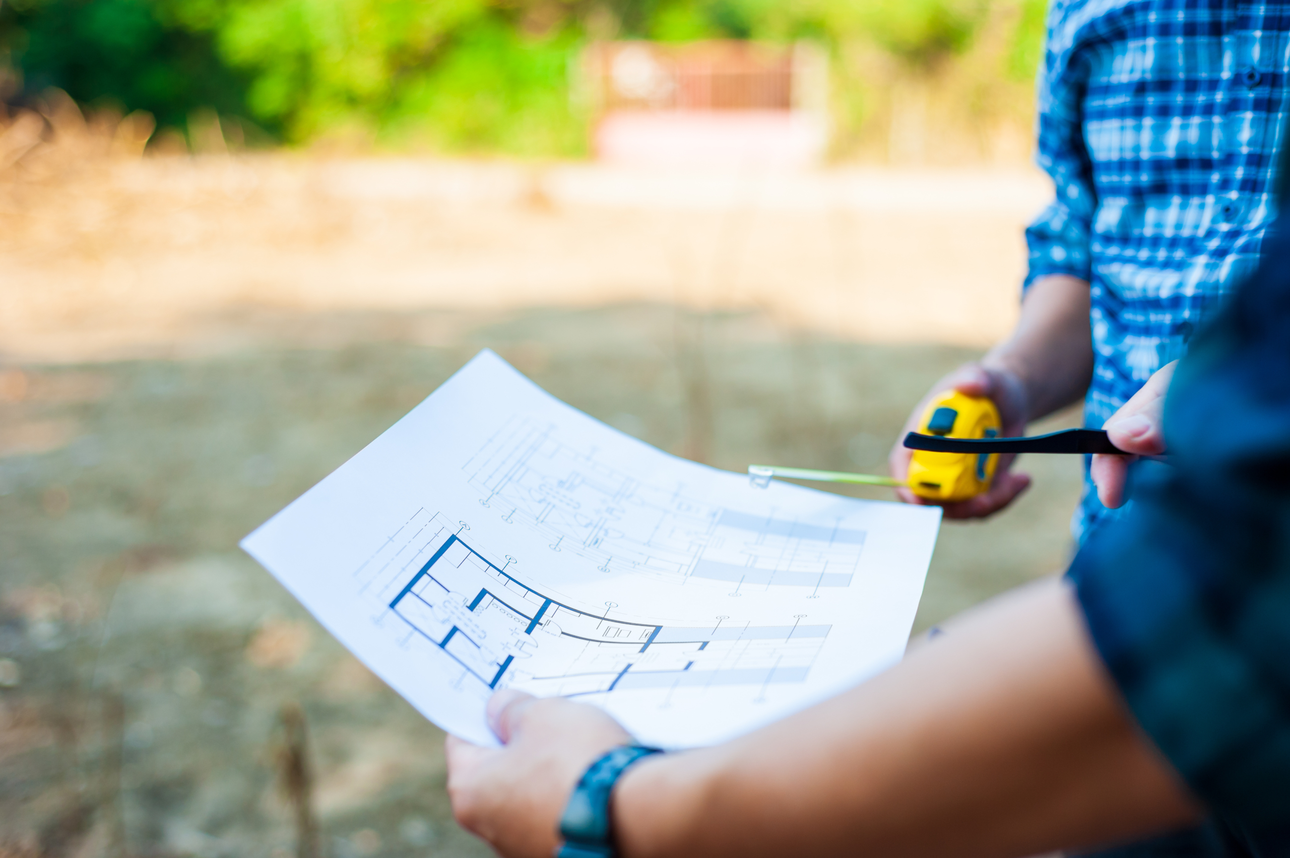 Contractors discuss land improvement planning for construction.