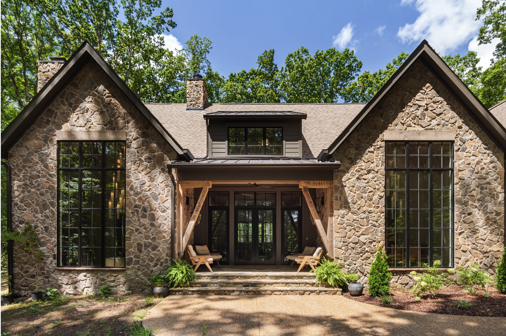 A home built by Hewn custom homes. The exterior is made mostly of stone.